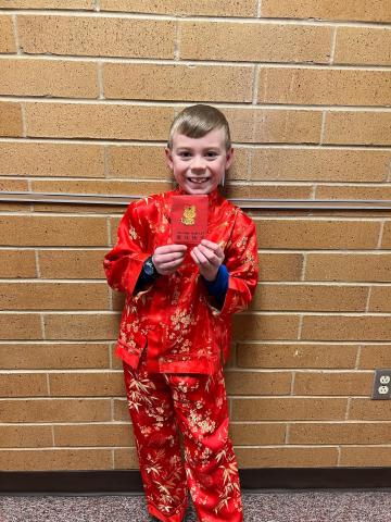 A student showing their red envelope