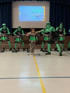 Kindergarten student playing with the green man group