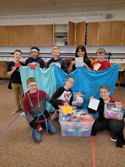 Members of the student council showing the blankets they made.